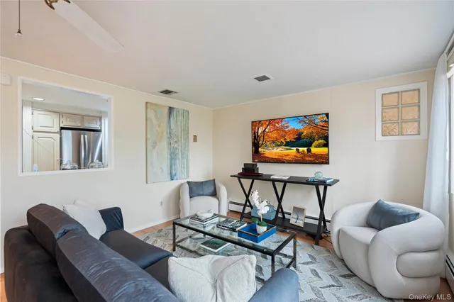 a living room with furniture a rug and a flat screen tv
