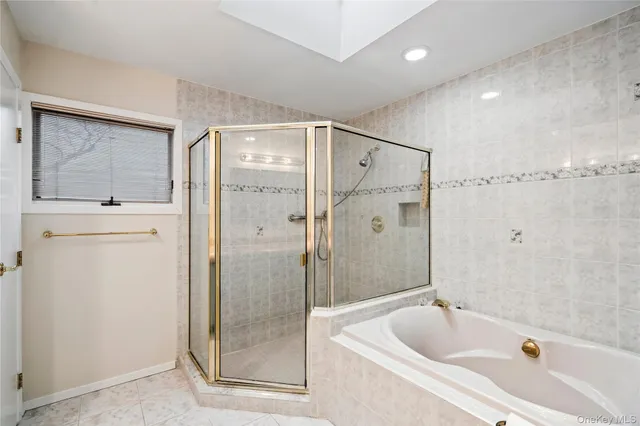 a bathroom with a tub a sink and shower