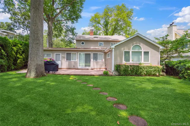 a front view of a house with a garden and yard