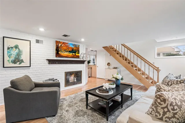 a living room with furniture a rug and a fireplace