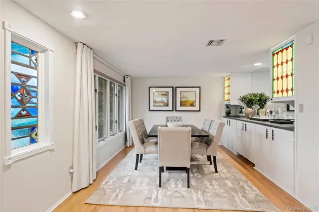 a view of a dining room with furniture and a window