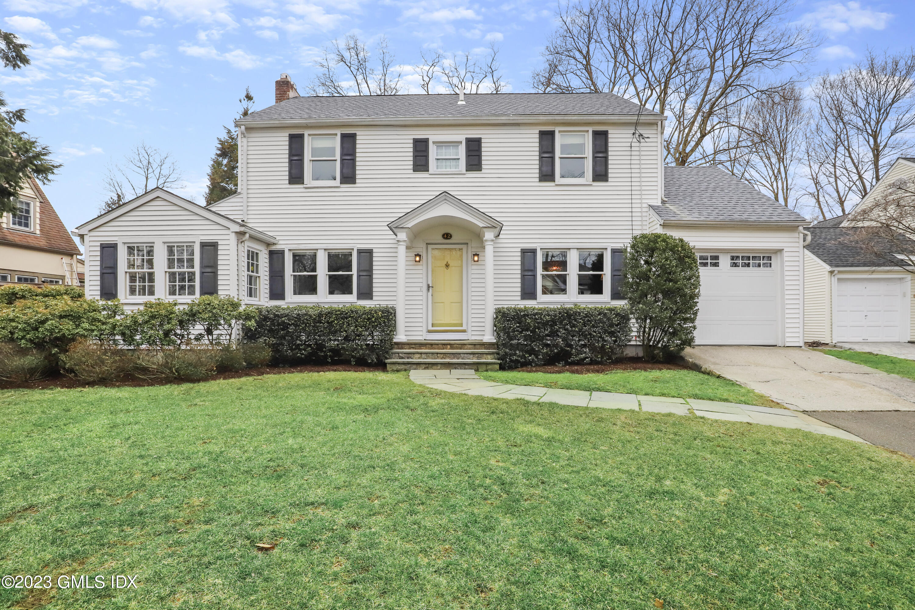 42 Oval Avenue Riverside, CT 06878 - Photo 1 of 29 a front view of a house with a yard and garage