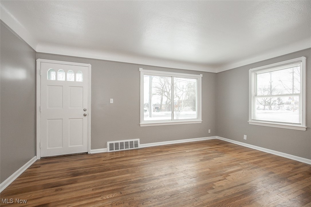 12328 Granger Road Cleveland, OH 44125 - Photo 9 of 37 Foyer entrance with plenty of natural light and hardwood / wood-style flooring