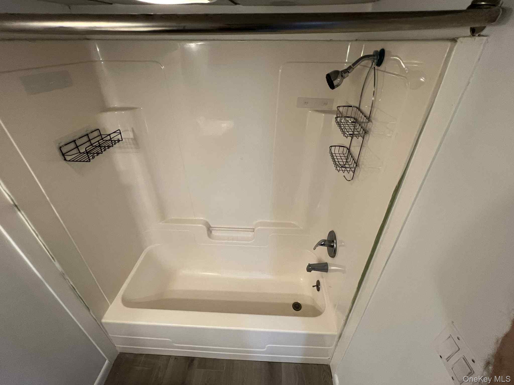 27 Blydenburgh Road Centereach, NY 11720 - Photo 10 of 11 a bathroom with a bathtub