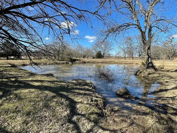 a view of a yard with wooden fence