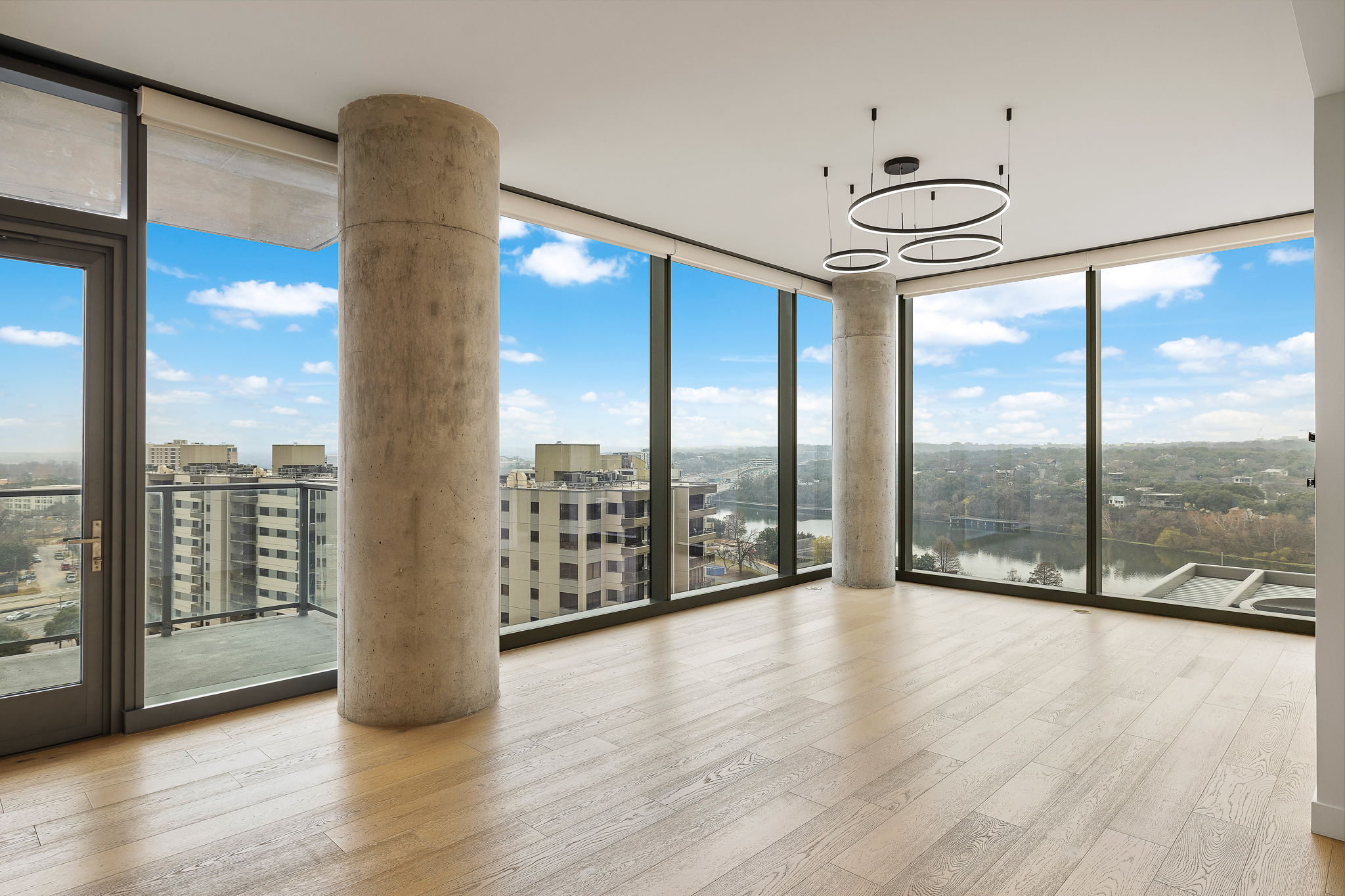 44 East Avenue, Unit 1210 Austin, TX 78701 - Photo 1 of 40 Living room featuring floor to ceiling windows, light wood floors, and plenty of natural light