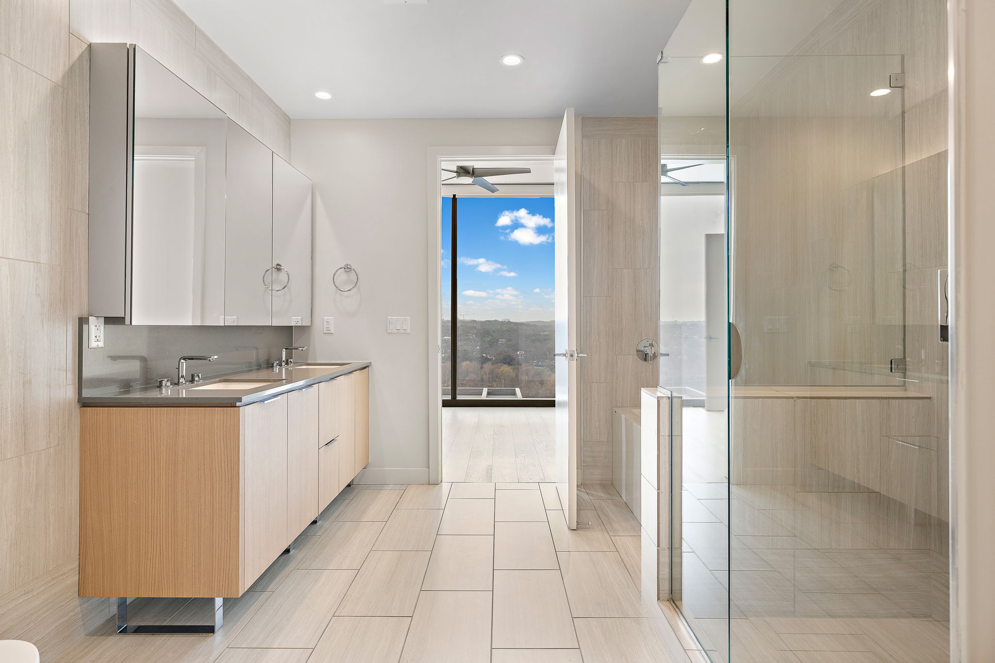 44 East Avenue, Unit 1210 Austin, TX 78701 - Photo 12 of 40 Master Bathroom featuring double vanity, a stall shower, and recessed lighting