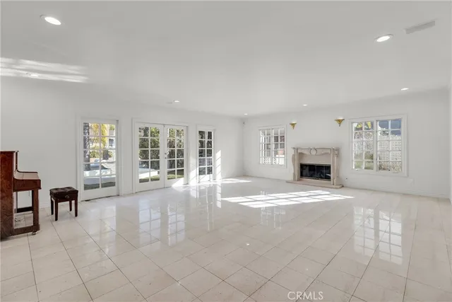 a view of empty room with fireplace and window