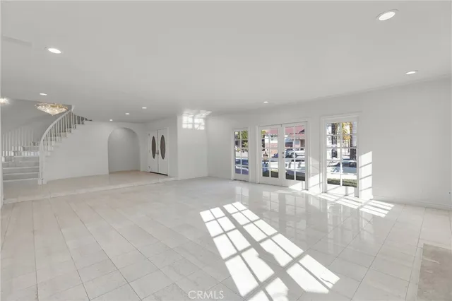 a living room with a fireplace and windows