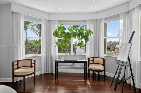 a bathroom with a granite countertop toilet a sink and a mirror