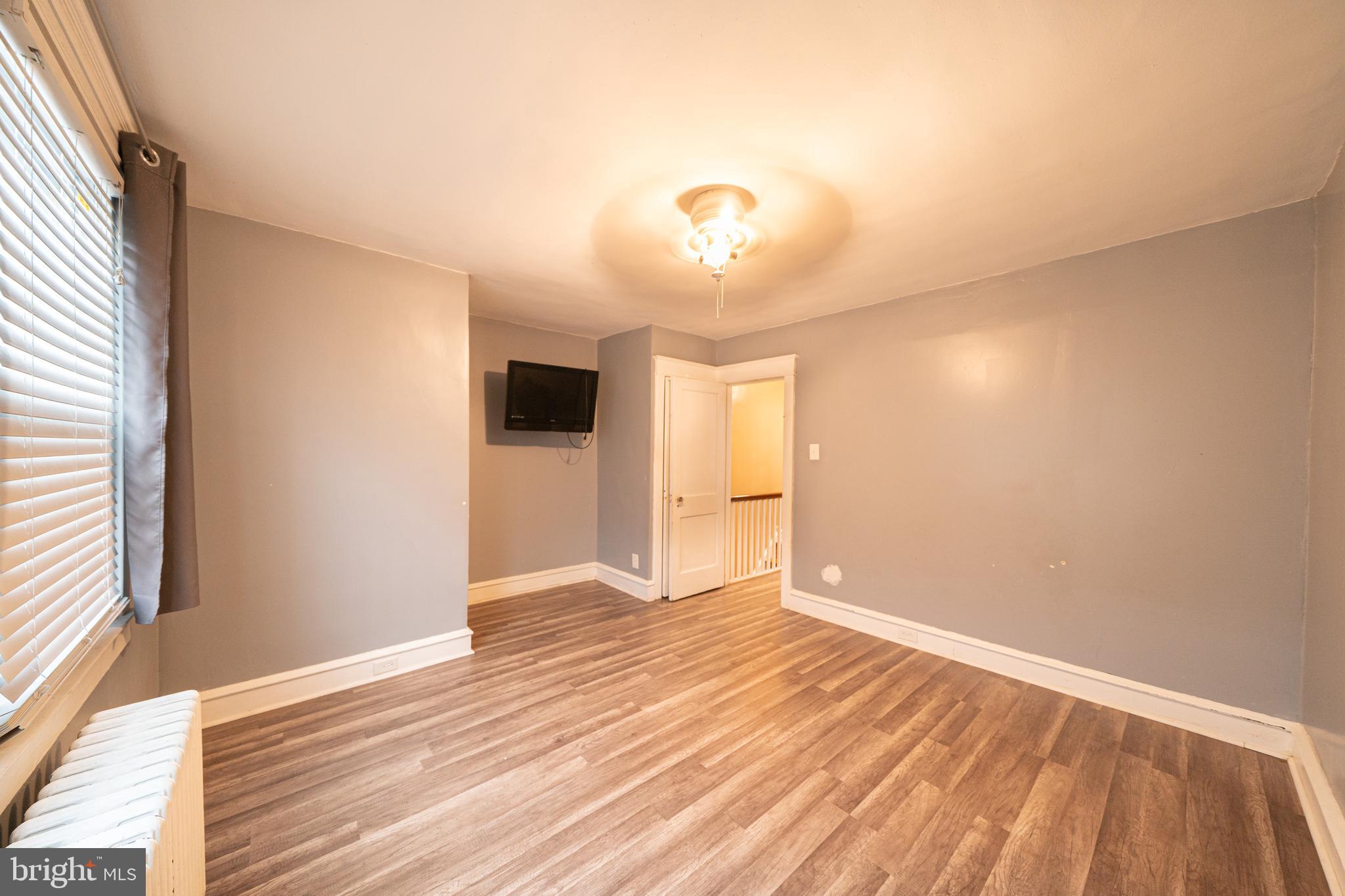 4141 Stirling Street Philadelphia, PA 19135 - Photo 12 of 24 wooden floor in an empty room with a window
