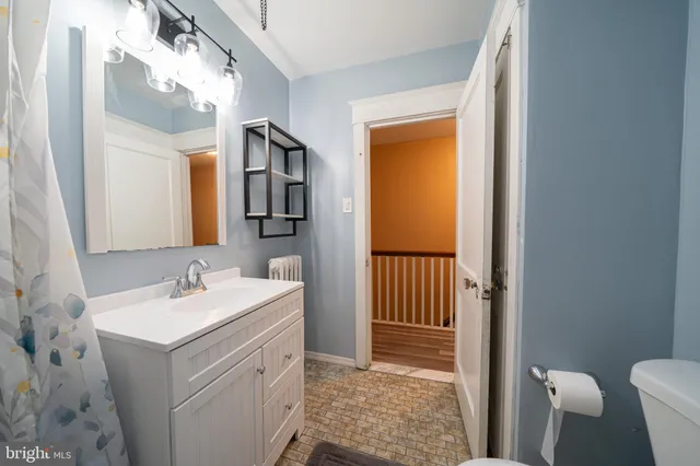 a bathroom with a sink vanity toilet and shower