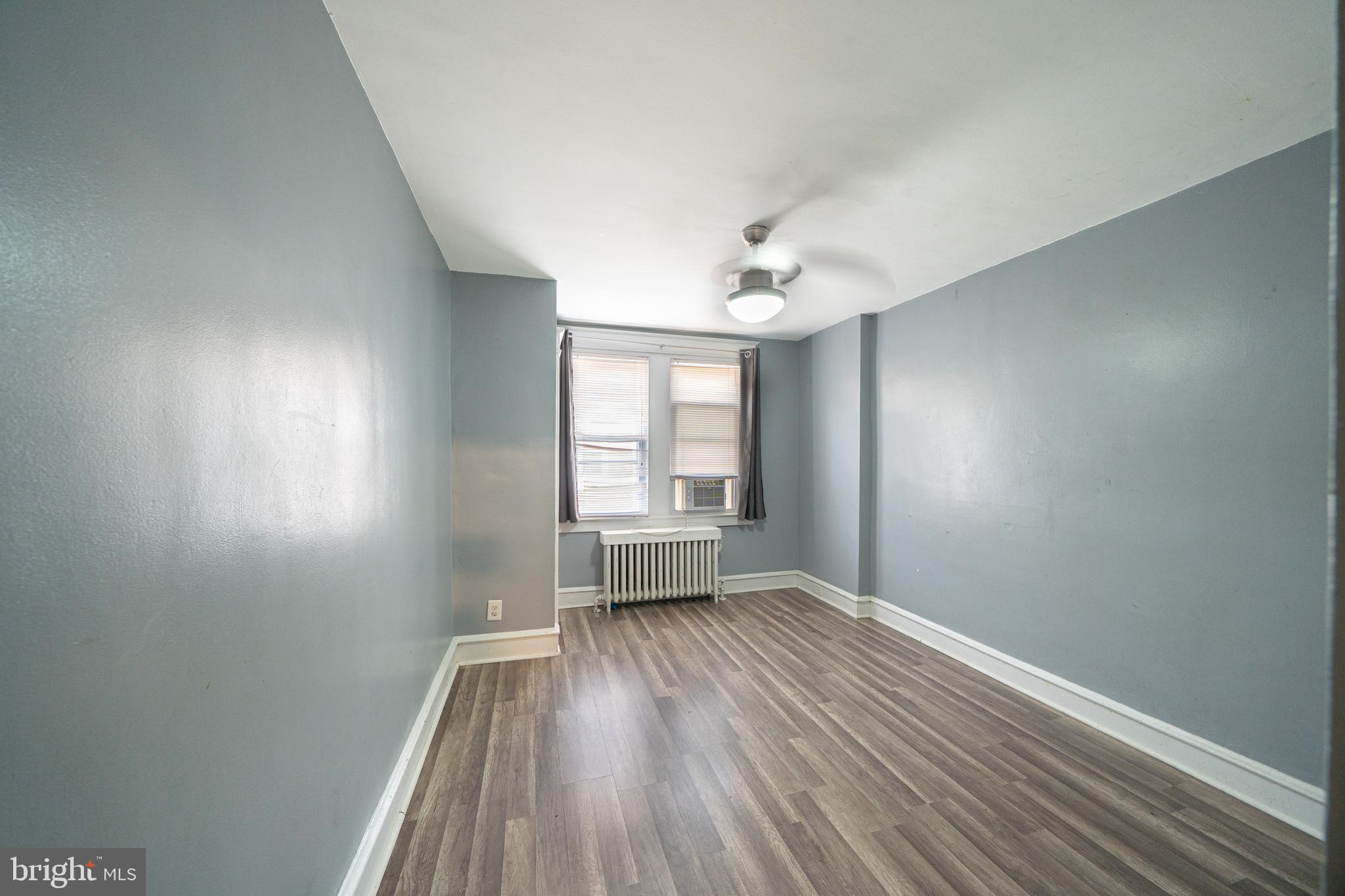4141 Stirling Street Philadelphia, PA 19135 - Photo 17 of 24 wooden floor in an empty room with a window