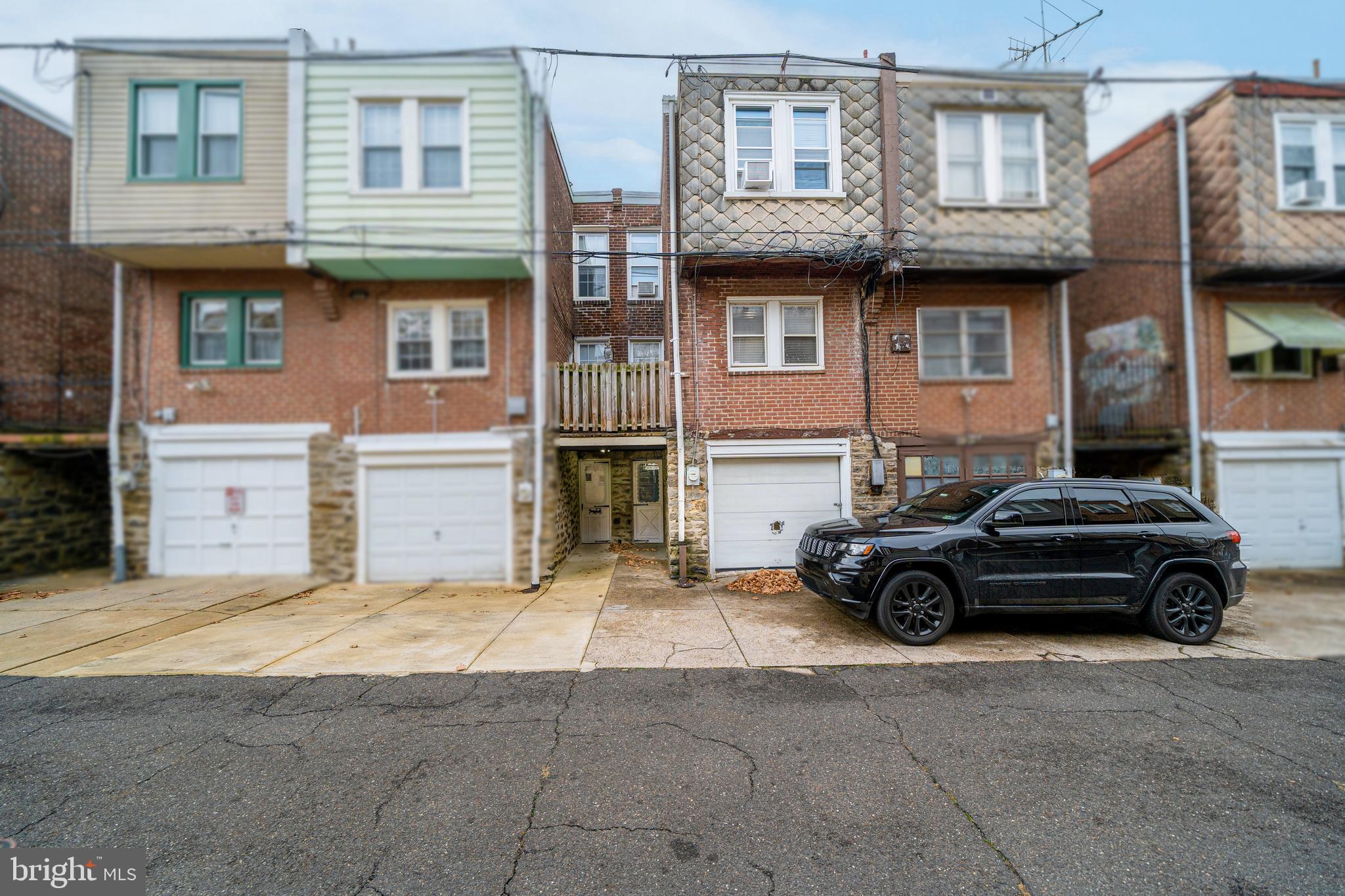 4141 Stirling Street Philadelphia, PA 19135 - Photo 22 of 24 a car parked in front of a brick house