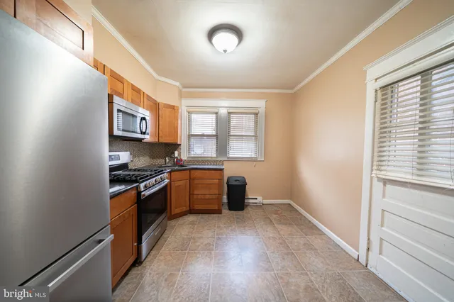 a kitchen with stainless steel appliances granite countertop a stove and a refrigerator
