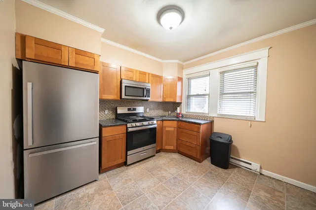 a kitchen with stainless steel appliances granite countertop a refrigerator stove a sink dishwasher and microwave