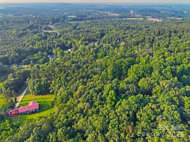 an aerial view of a houses with a yard