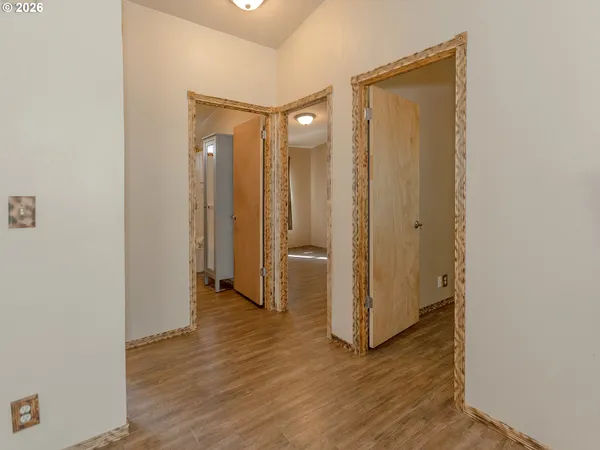 a view of a hallway with wooden floor