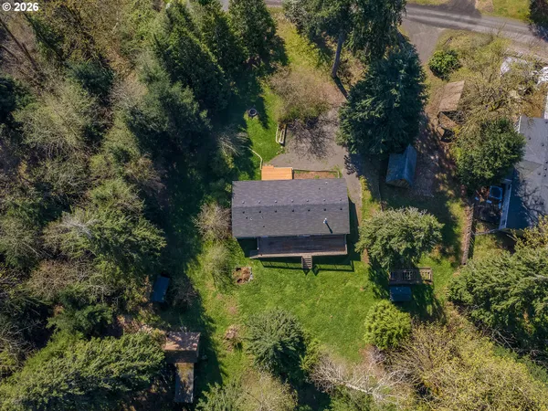 an aerial view of a house with garden space and a street view