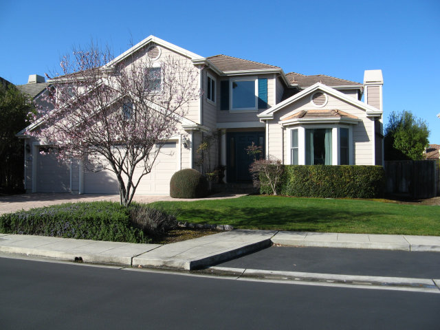 151 Cypress Point Road Half Moon Bay, CA 94019 - Photo 1 of 25 a front view of a house with a yard and garage