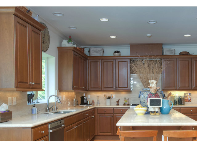 151 Cypress Point Road Half Moon Bay, CA 94019 - Photo 13 of 25 a kitchen with kitchen island granite countertop a sink cabinets and window