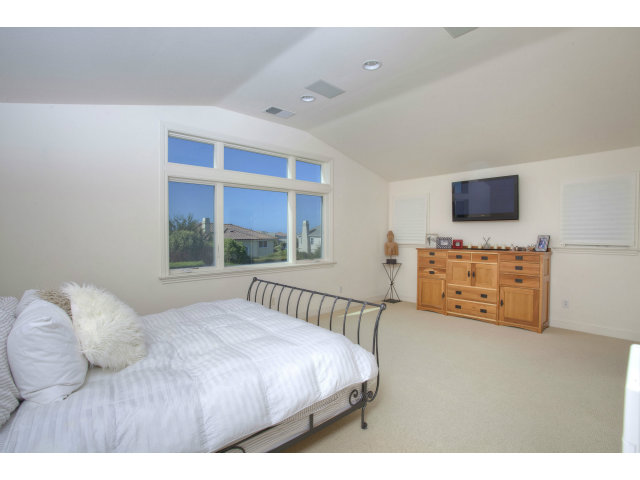 151 Cypress Point Road Half Moon Bay, CA 94019 - Photo 17 of 25 a bedroom with a bed and a flat tv screen on the dresser