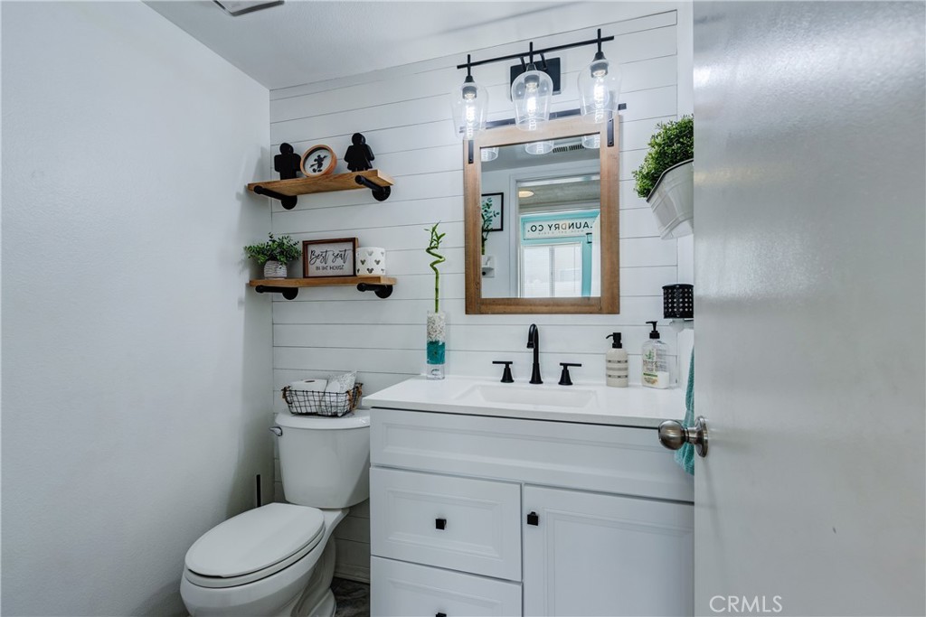 25588 Pelion Road Menifee, CA 92584 - Photo 12 of 43 a bathroom with a sink a toilet and mirror