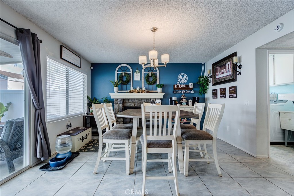 25588 Pelion Road Menifee, CA 92584 - Photo 13 of 43 a view of a dining room with furniture and a chandelier