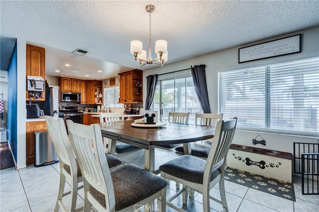25588 Pelion Road Menifee, CA 92584 - Photo 14 of 43 a view of a dining room with furniture window and wooden floor