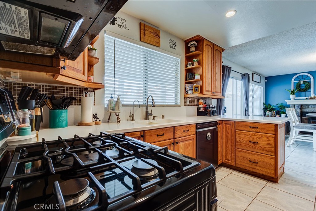 25588 Pelion Road Menifee, CA 92584 - Photo 19 of 43 a kitchen with stainless steel appliances granite countertop a stove and a sink