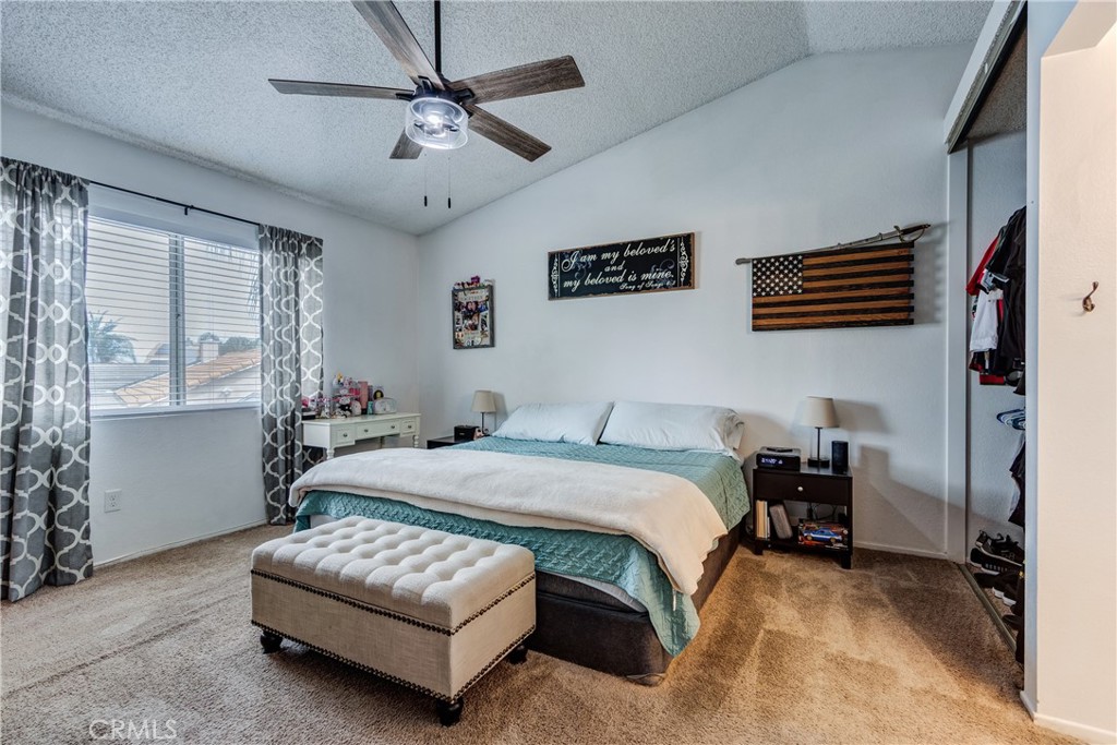 25588 Pelion Road Menifee, CA 92584 - Photo 21 of 43 a bedroom with a bed and a chandelier