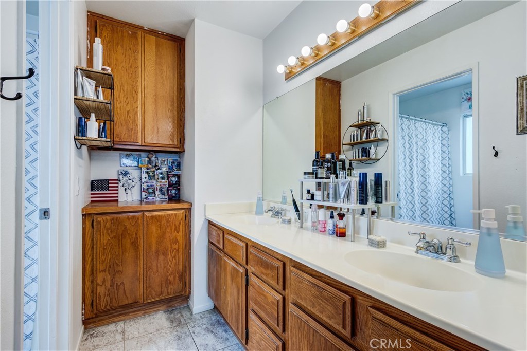 25588 Pelion Road Menifee, CA 92584 - Photo 24 of 43 a bathroom with a sink and a mirror