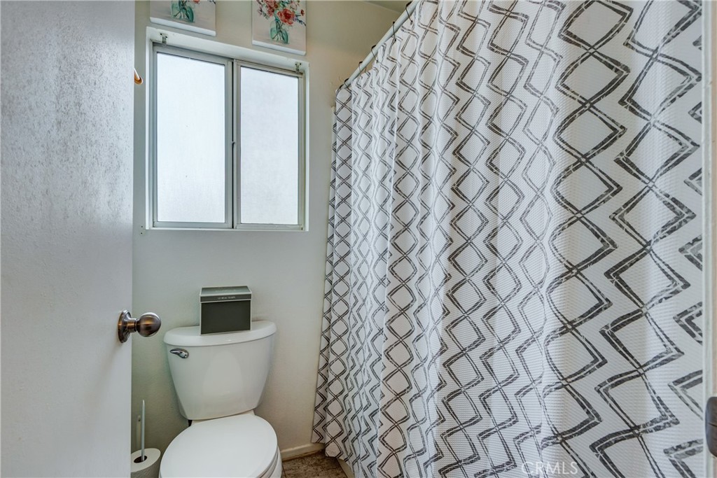 25588 Pelion Road Menifee, CA 92584 - Photo 25 of 43 a white toilet sitting next to a shower curtain