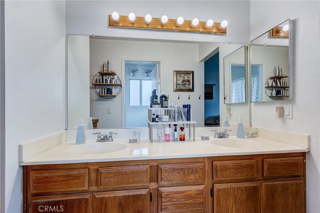 25588 Pelion Road Menifee, CA 92584 - Photo 26 of 43 a bathroom with a sink and a mirror