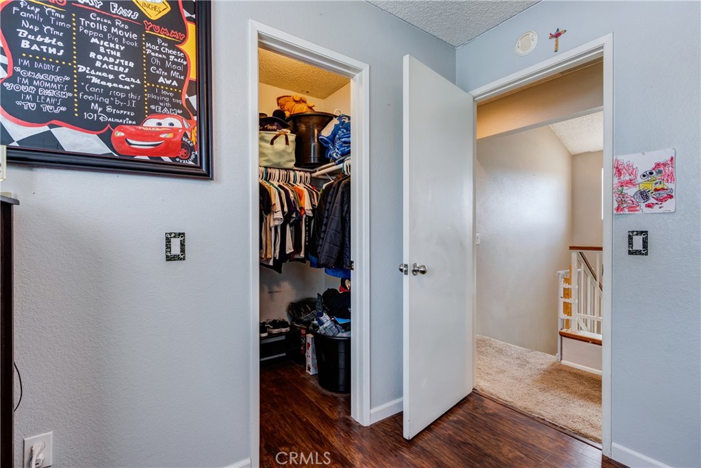25588 Pelion Road Menifee, CA 92584 - Photo 30 of 43 a view of a hallway with wooden floor and a workspace