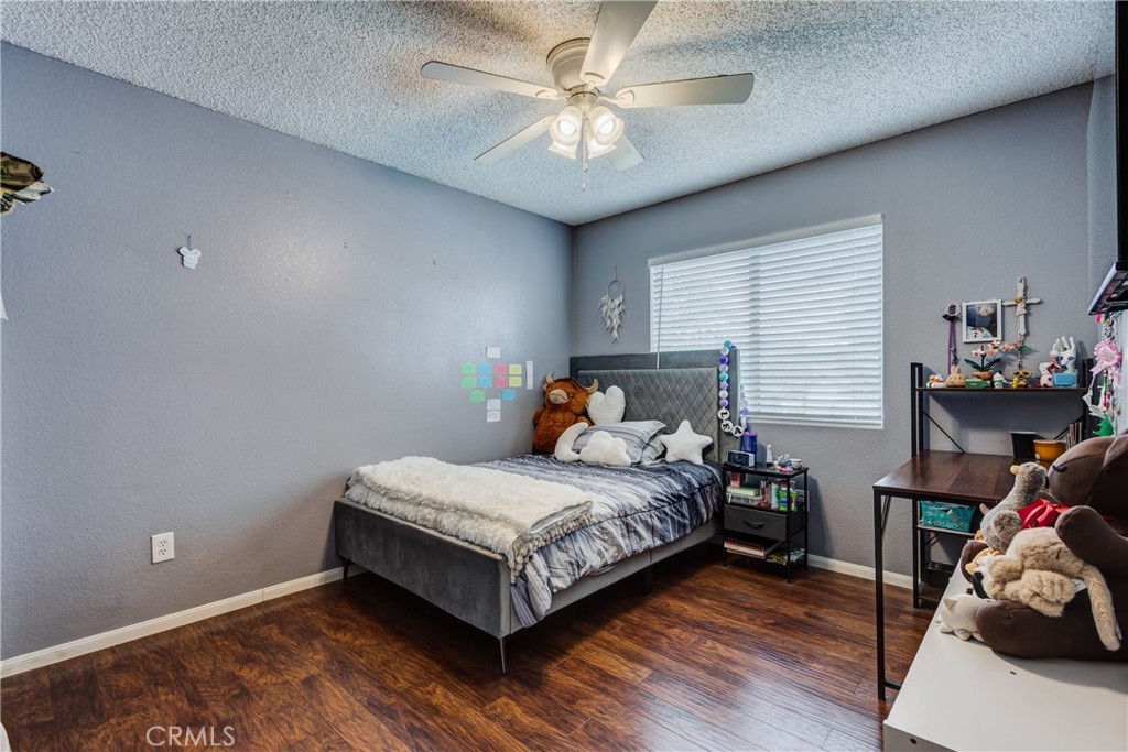 25588 Pelion Road Menifee, CA 92584 - Photo 31 of 43 a bedroom with a bed and a chandelier