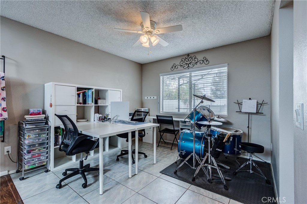 25588 Pelion Road Menifee, CA 92584 - Photo 9 of 43 a view of a workspace with furniture and a potted plant