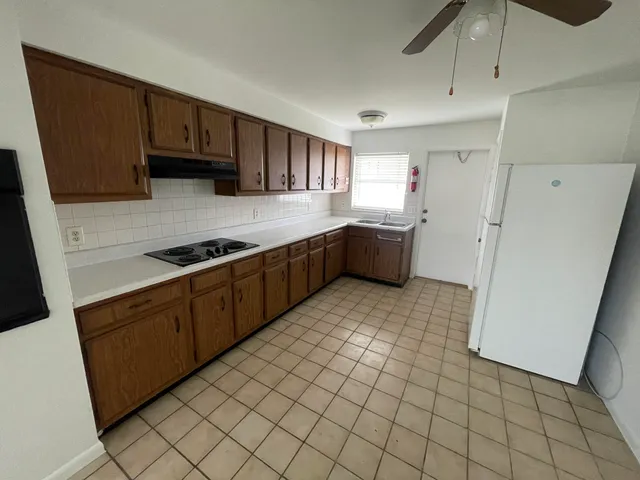 a kitchen with stainless steel appliances a refrigerator sink and cabinets