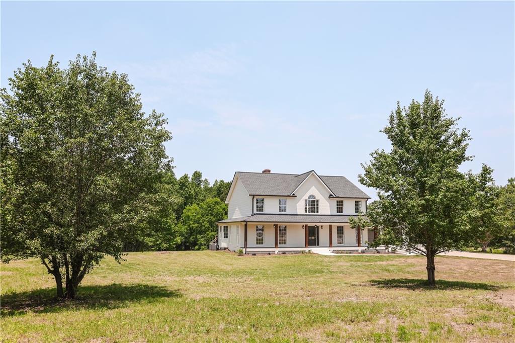 6835 Crossroads Road Cumming, GA 30041 - Photo 1 of 1 a front view of a house with a garden and trees