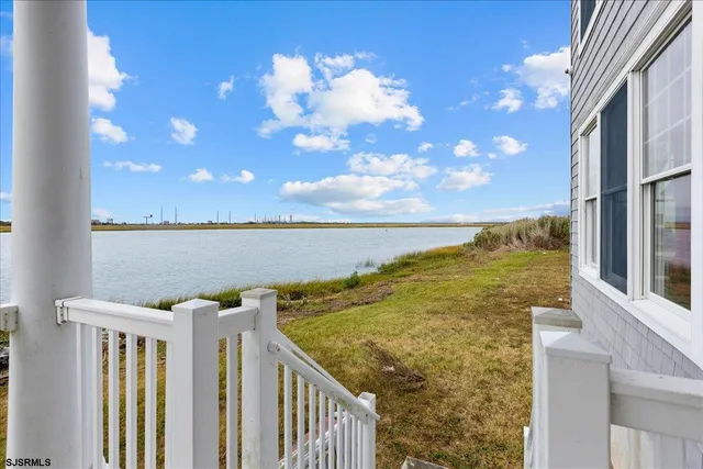 a bathroom with a granite countertop sink a mirror and a bathtub