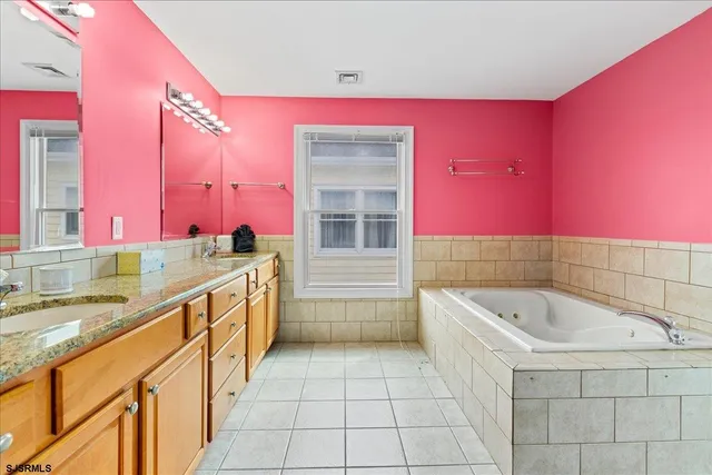 a room with gym equipment and wooden floor