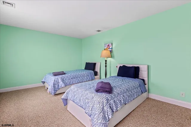 an aerial view of a house with a garden and lake view