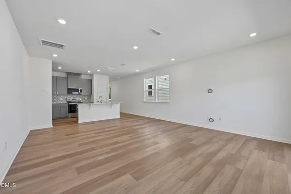 an empty room with a empty space and windows
