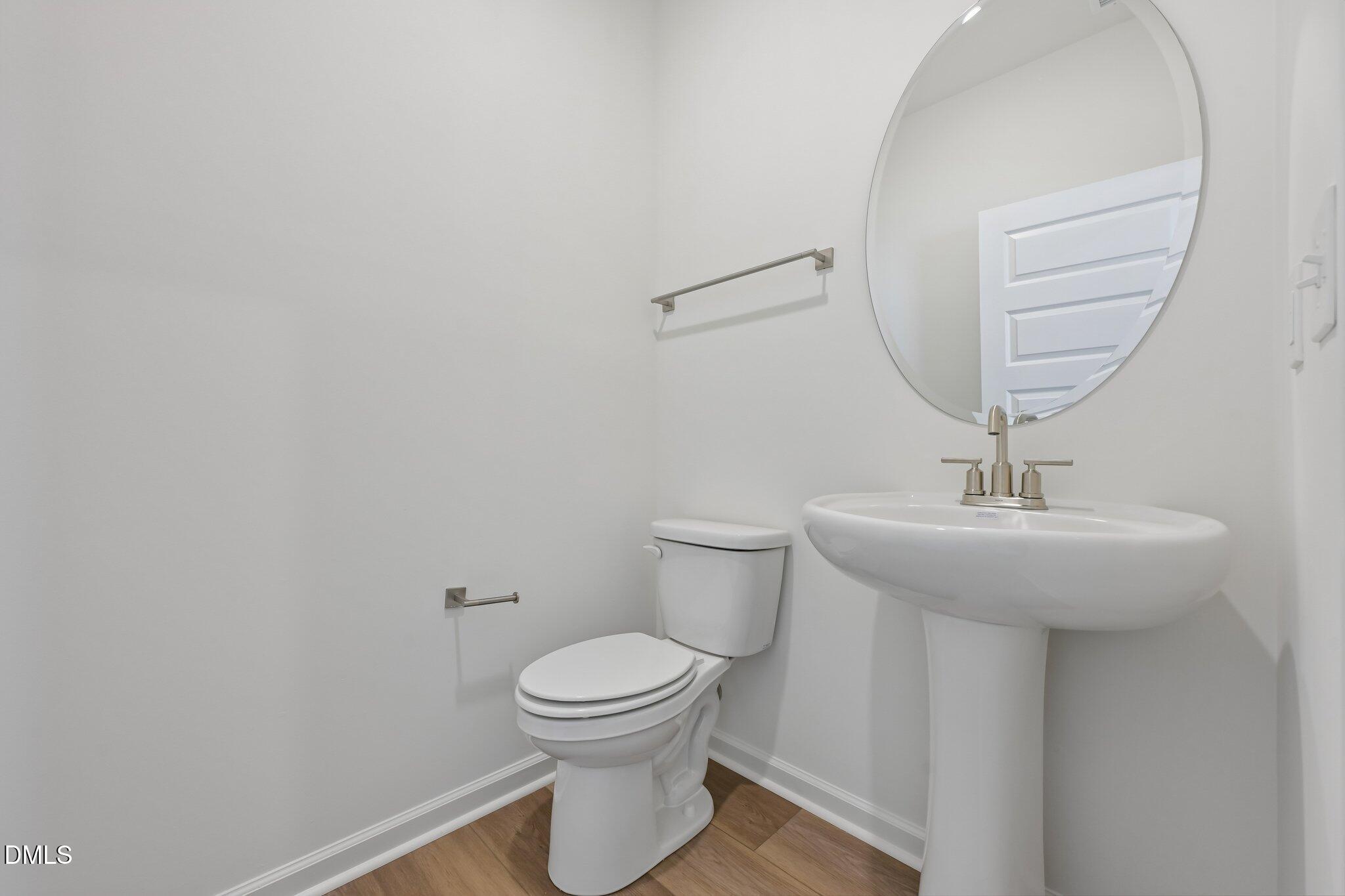 2206 Rabbitbrush Street Durham, NC 27704 - Photo 20 of 49 a bathroom with a sink a toilet and mirror