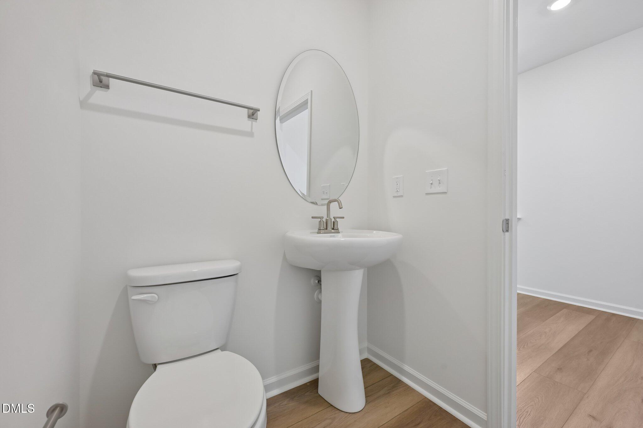 2206 Rabbitbrush Street Durham, NC 27704 - Photo 21 of 49 a bathroom with a toilet sink and mirror