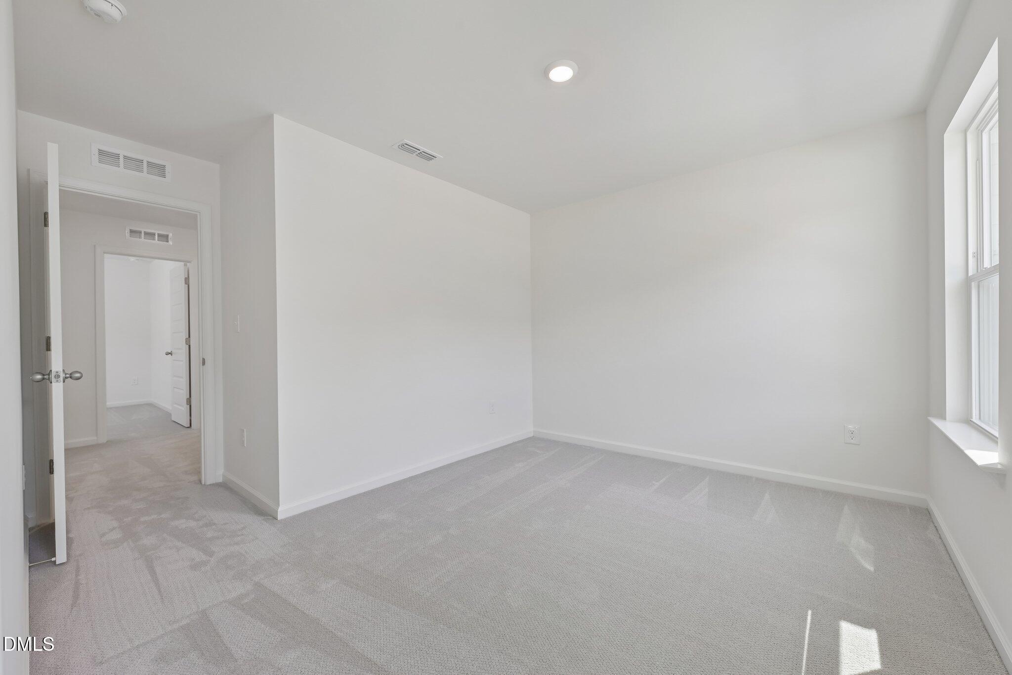 2206 Rabbitbrush Street Durham, NC 27704 - Photo 24 of 49 an empty room with a empty space and windows