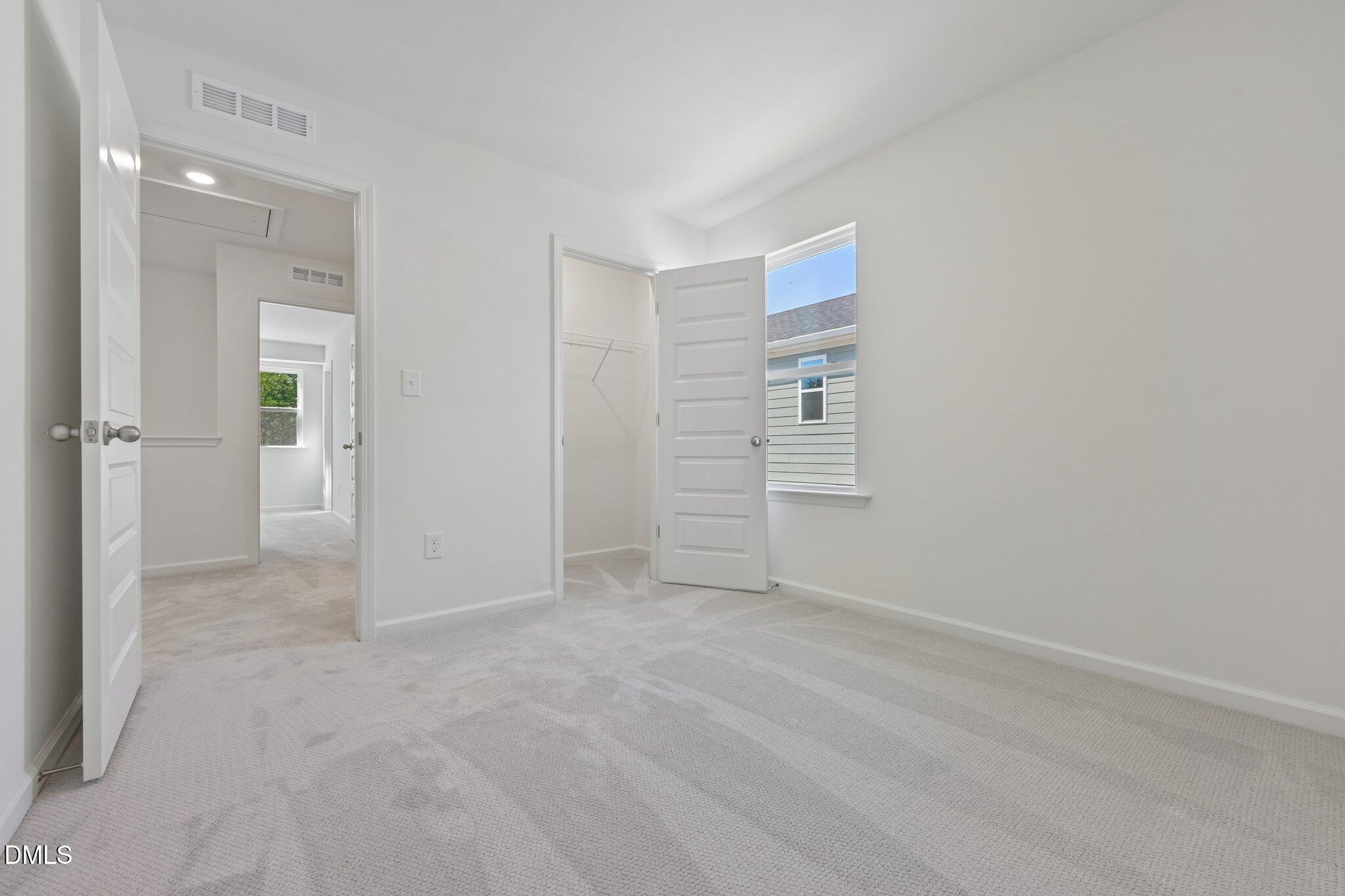 2206 Rabbitbrush Street Durham, NC 27704 - Photo 28 of 49 an empty room with windows and closet