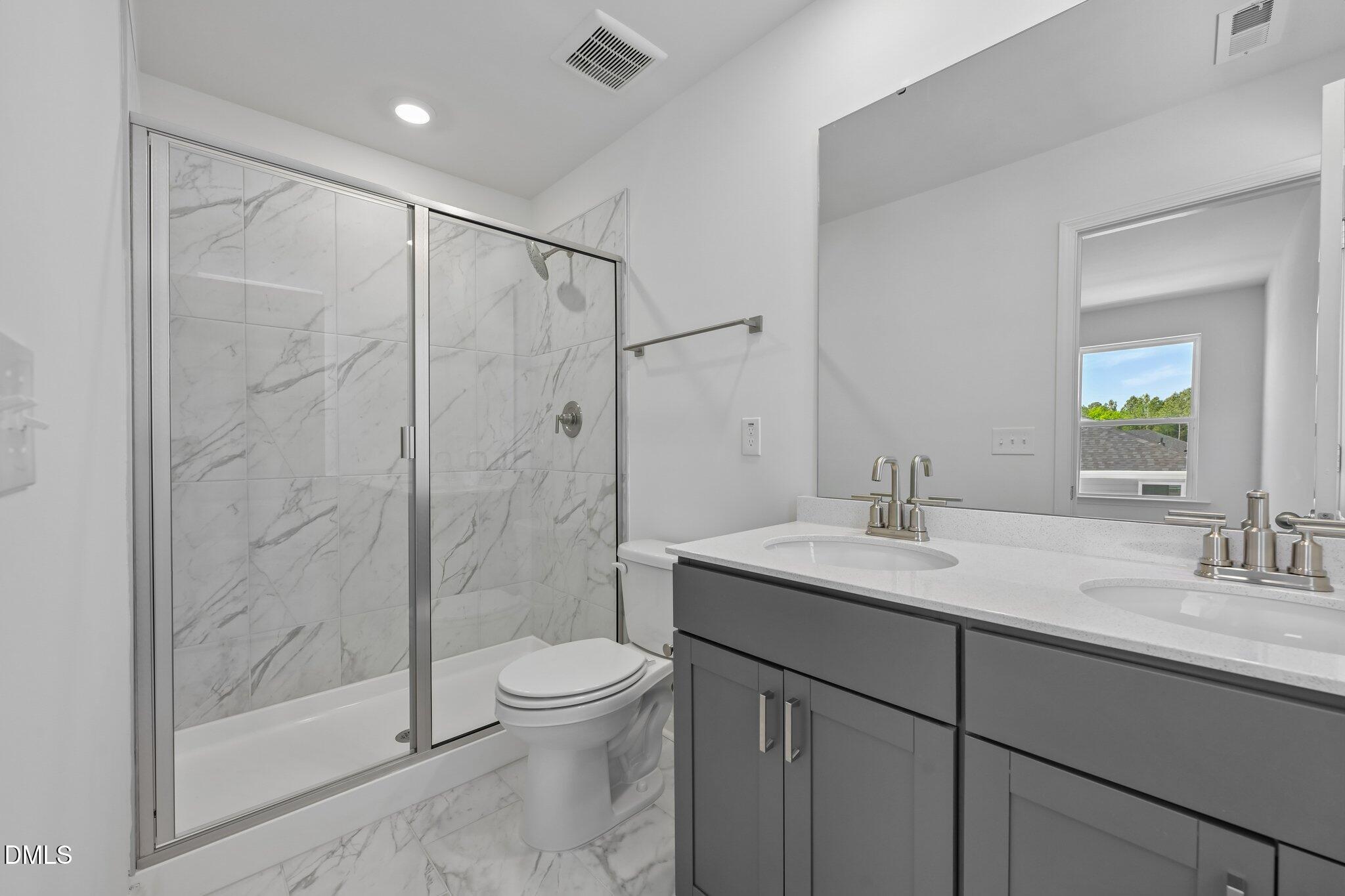 2206 Rabbitbrush Street Durham, NC 27704 - Photo 35 of 49 a bathroom with a sink toilet and shower