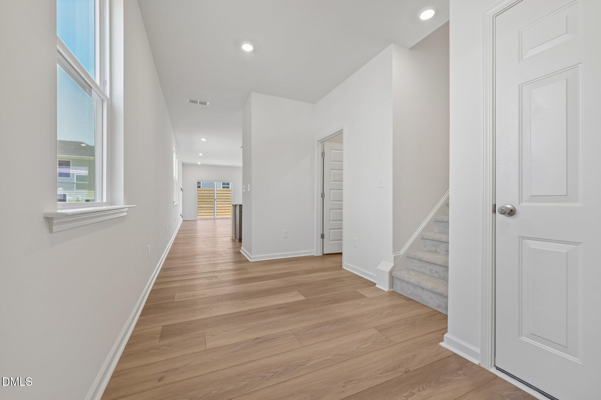 2206 Rabbitbrush Street Durham, NC 27704 - Photo 6 of 49 a view of a hallway with wooden floor and staircase