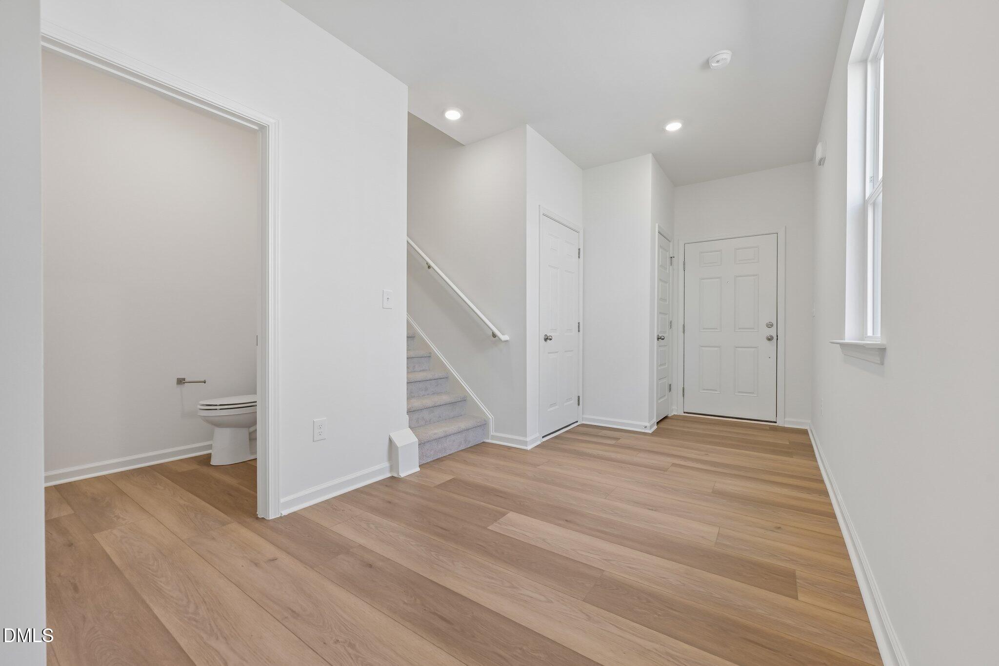2206 Rabbitbrush Street Durham, NC 27704 - Photo 7 of 49 a view of an empty room with wooden floor and closet